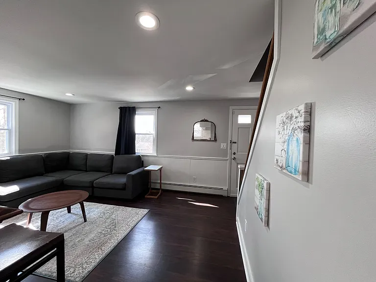 Open living area with sectional seating, large windows, and durable flooringideal for relaxing or entertaining.