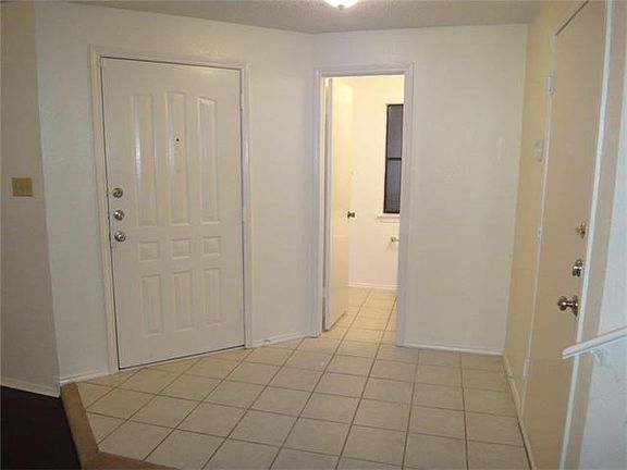 Entry opens to formal dining area, living room, half bathroom, stairs and garage.