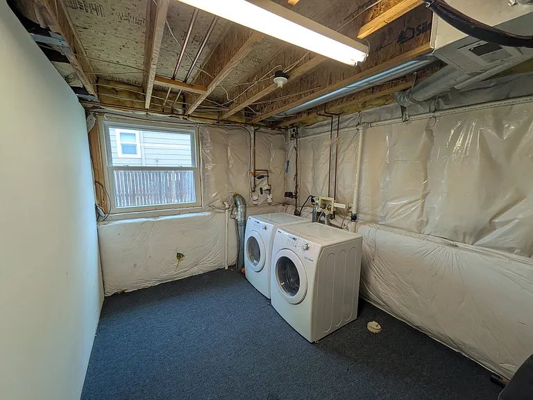 Laundry Room with full size front loading washer/dryer (Additional storage area)