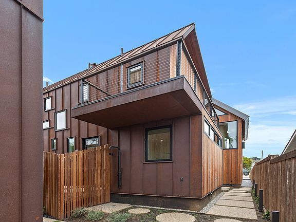 Walkway to the unit and modern exterior facing soutn.