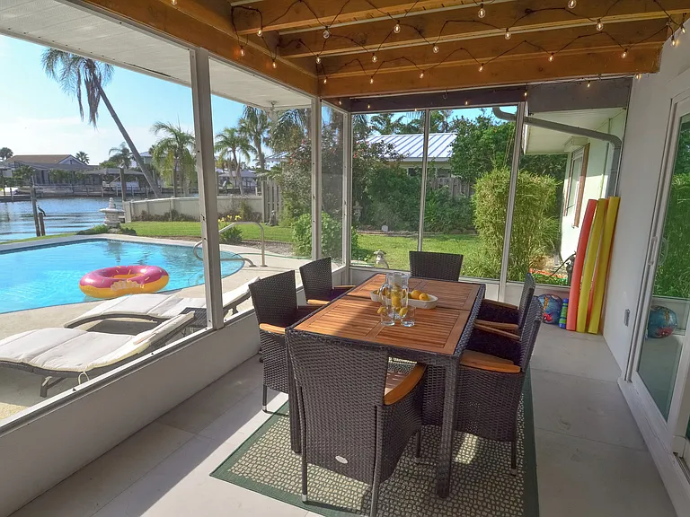 Screened in patio with 6 seat dining set right off of the living room