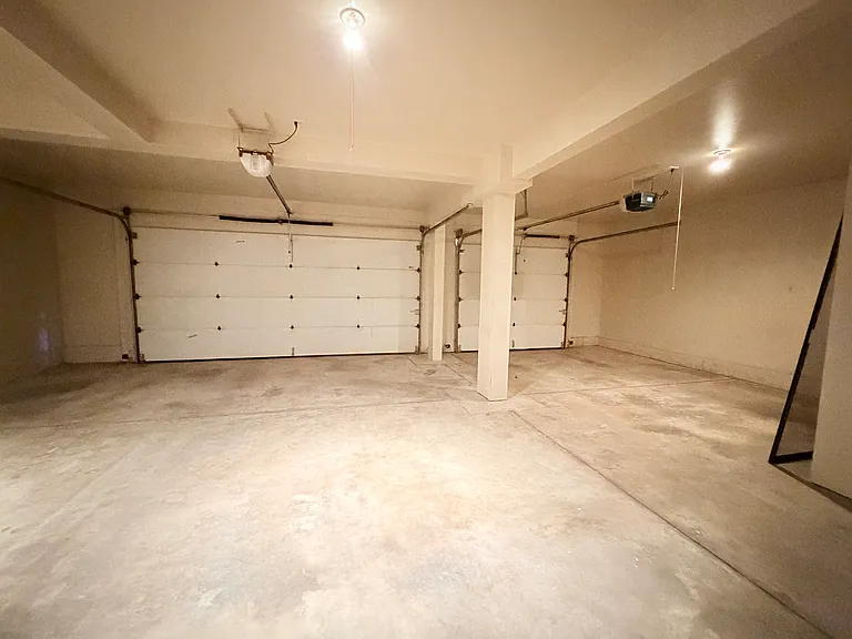 Oversized attached 3-car garage includes door to the front porch as well as interior to mudroom of the home