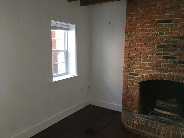 Second floor bedroom with decorative fireplace.