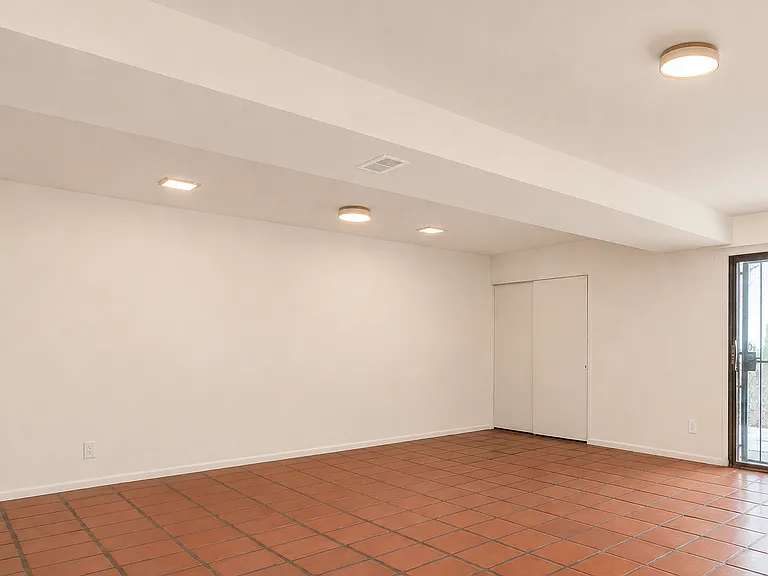 Massive lower-level flex space. It has a closet, a wet bar, a 3/4 bathroom, and a separate entrance through the walk-out patio. The laundry room is also on this floor.
