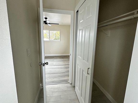 Closet in bathroom with view of bedroom