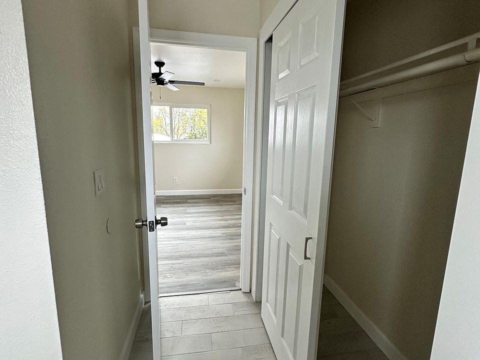 Closet in bathroom with view of bedroom