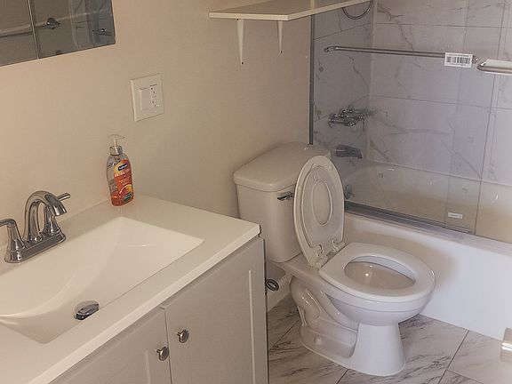 Modernized bathroom with glass enclosure