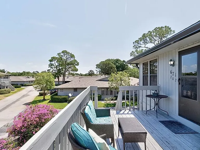 Outside seating with two couches, chairs, and tables