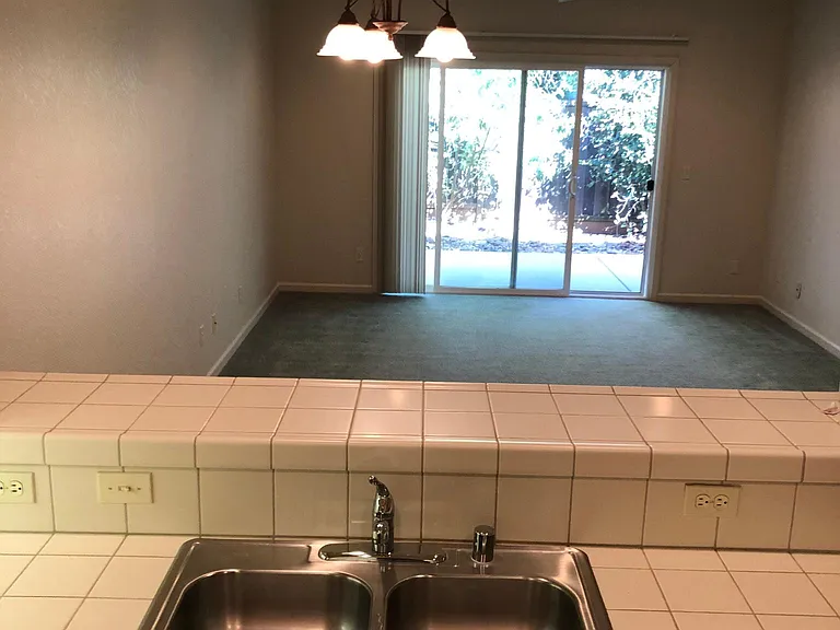Kitchen looks out to great room and then out to private patio/garden area.