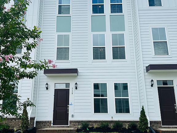 The home's primary entry, enhanced by thoughtful landscaping.