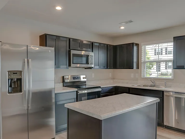 Kitchen with stainless steel appliances and stationary large island