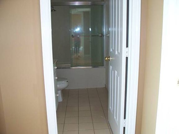 Tile Floor, Vanity & Soaking Tub/Shower in Bath