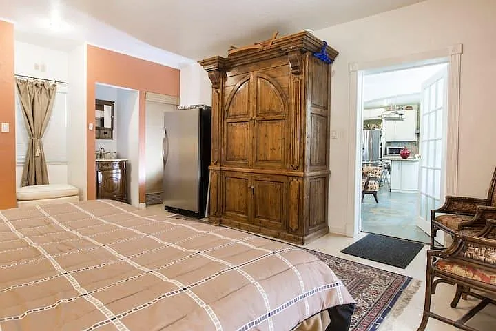 This bedroom has another King bed a vanity and a laundry room.