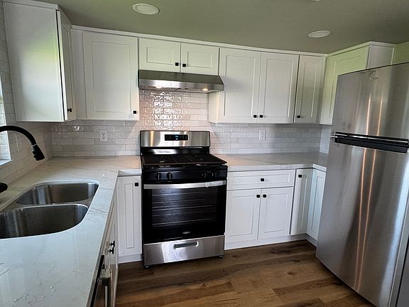 Brand new appliances, Whirlpool Gas Range / Oven, Whirlpool Fridge, GE Dishwasher. Stone counters and a double sink.