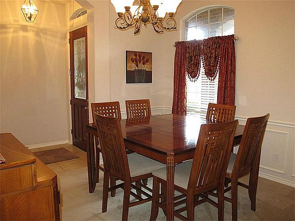 Dining at it's finest in this elegant formal dining room featuring a beautiful chandelier, chair rail and picture frame moldings.