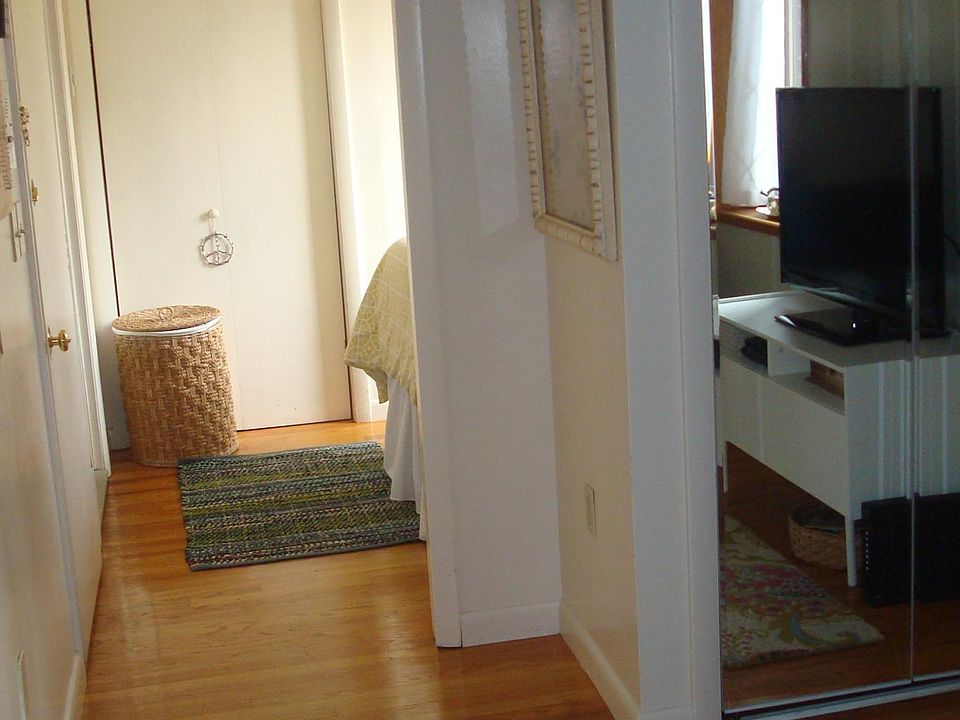 Looking down the hallway from the living room to the bedroom alcove