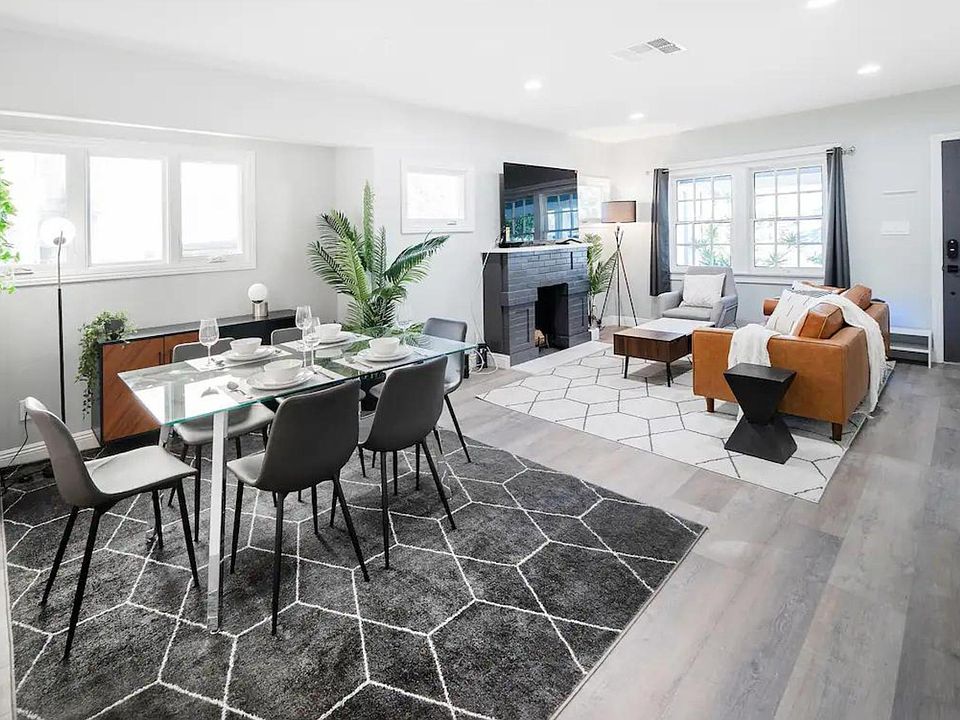 A clean, modern interior design transforms the living room into a vibrant, yet inviting space, perfect for both daily living and entertaining. The sleek lines and minimalist decor create an uncluttered, visually appealing atmosphere, while cozy furnishing