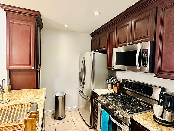 Kitchen with stainless steel appliances. Fridge is less than 1 year. Gas stove, built in microwave and dishwasher. Includes Culligan reverse osmosis water filtration system.