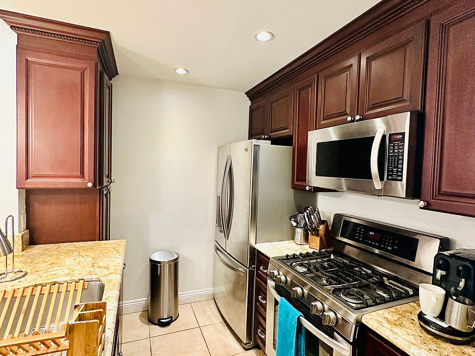Kitchen with stainless steel appliances. Fridge is less than 1 year. Gas stove, built in microwave and dishwasher. Includes Culligan reverse osmosis water filtration system.