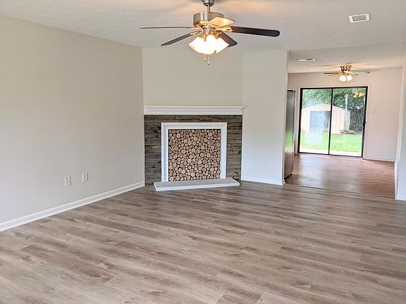 Living room with fireplace art piece.