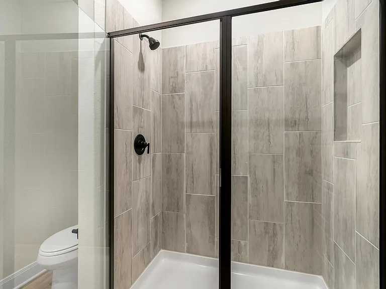 Step-in shower with tile detail in the master bathroom.