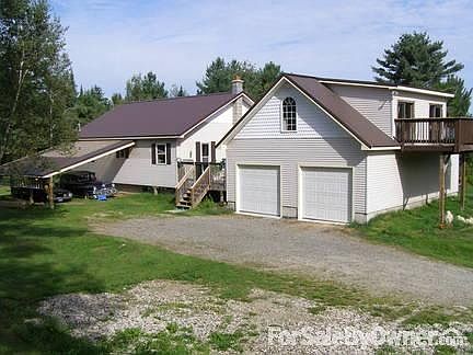 From the driveway
						:
						Very level easy in and out drive - Large yard grass to the wood line -