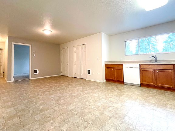 Looking from dining room toward bedroom and entry.