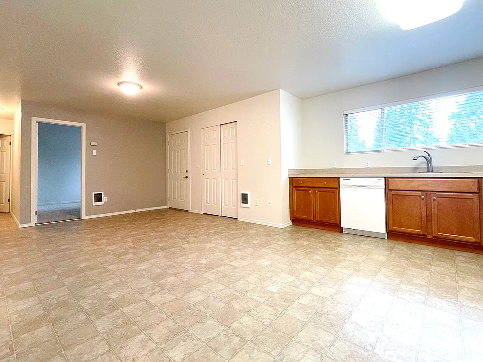 Looking from dining room toward bedroom and entry.