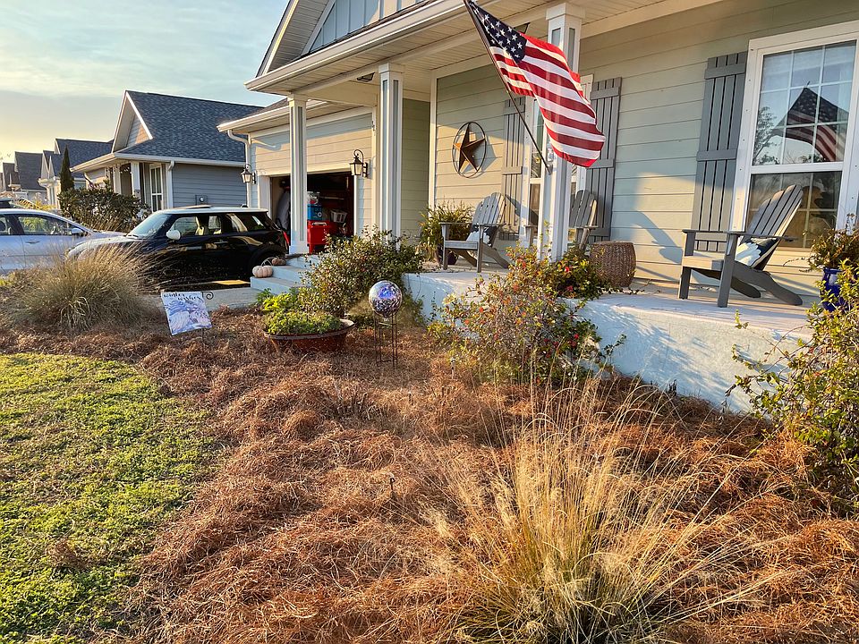 Landscaped front entry includes two nursery beds.