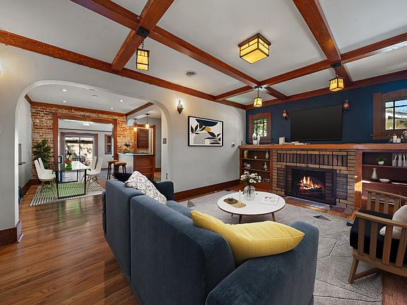 Living room to dining room and kitchen looking from the front door (virtually staged) electric fireplace insert use remote