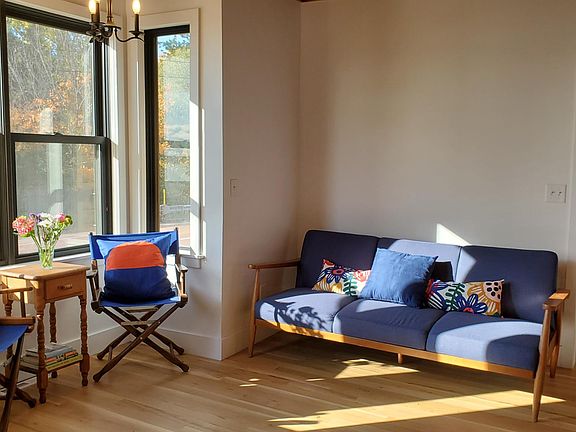 The south facing living room is inviting with this sun-filled nook. New windows and new oak wood floors are easy to maintain.