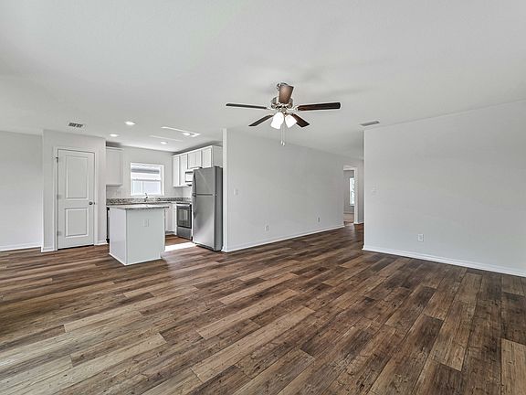 The Amelia has an open entertainment space that includes the living room, kitchen, and dining room