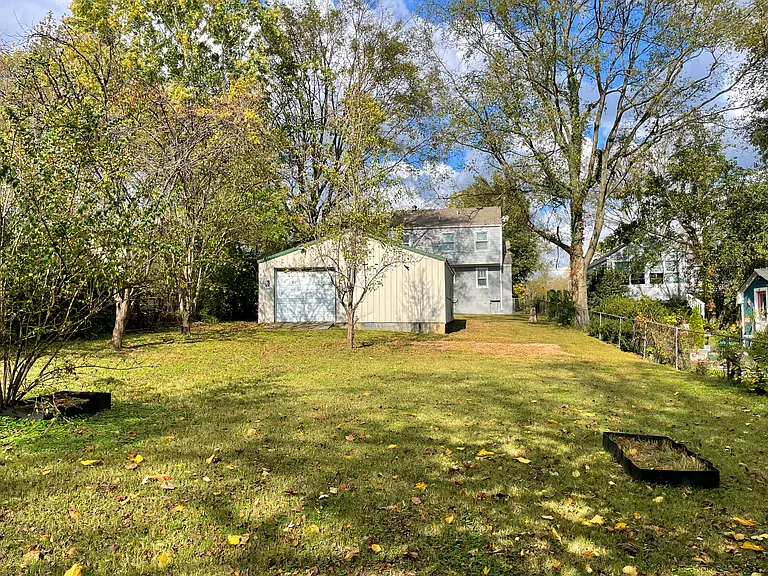 Backyard view towards the garage and back of house. So much space to run and garden!