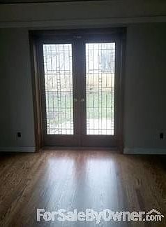 Den
						:
						Den with leaded glass french doors leads to back paver patio