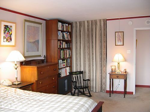 Bedroom entrance; walk-in closet behind curtain.