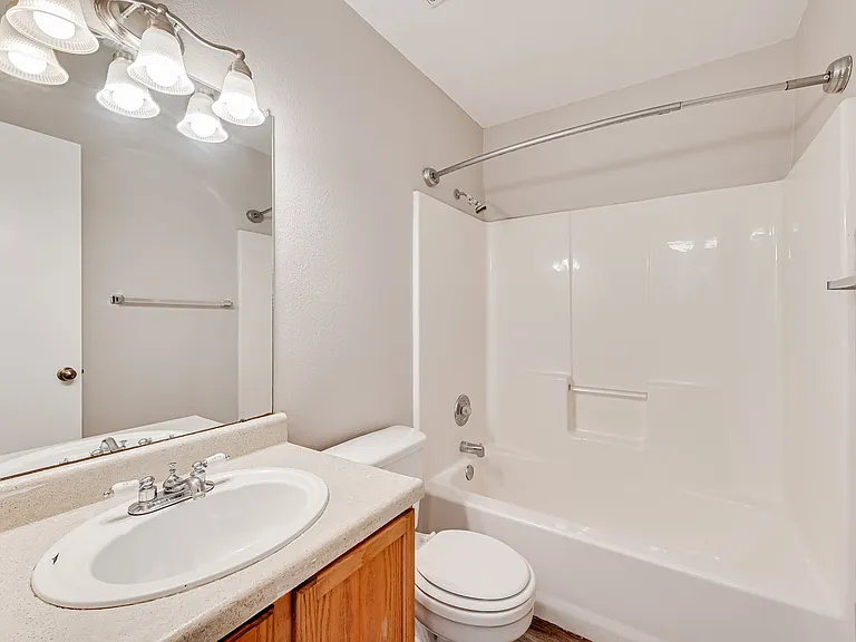 A clean and functional bathroom with a neutral design.