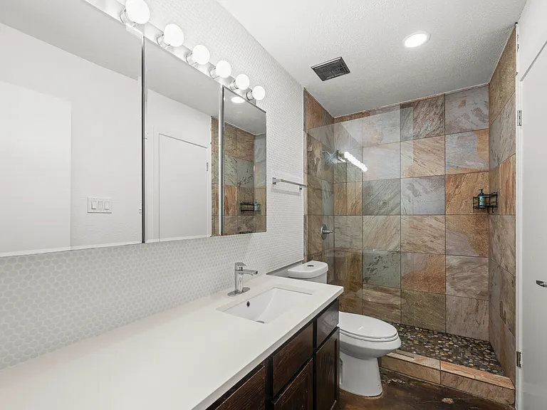 Modern updated bath with new white tile/ walk in tiled shower with frameless glass / Quartz counters~