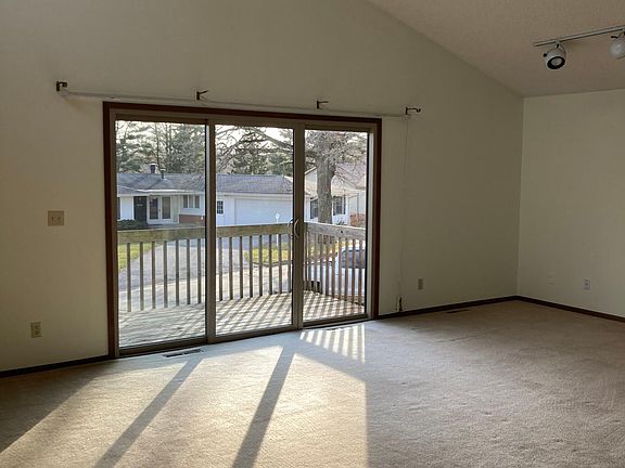 Living Room with vaulted ceiling and patio access.
