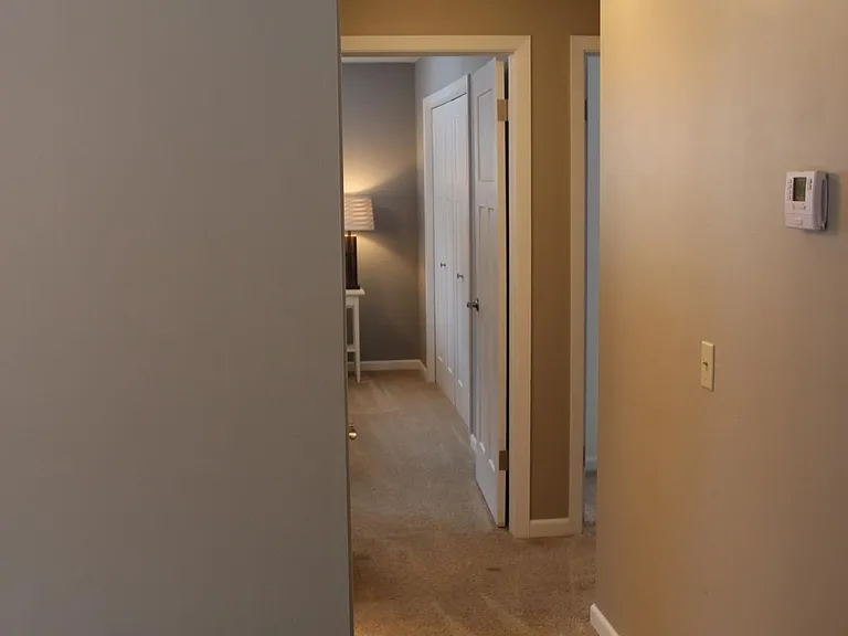 Hallway to bedrooms 1 and 2, office/bedroom option, and shared full bathroom.