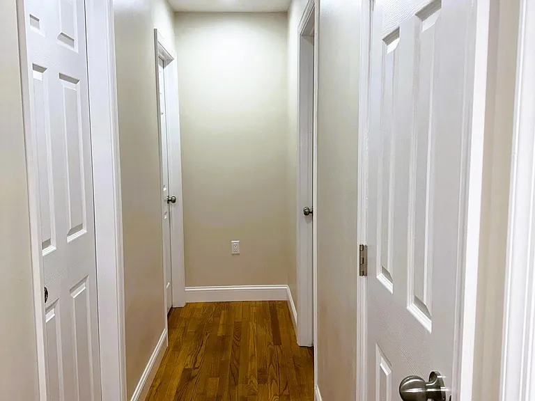 Hallway towards bedroom. 2 bedrooms on the left. Main bathroom, Hallway Closet and Masterbedroom on the left.