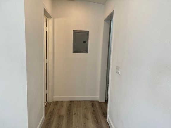 Hallway leading to bedroom and bathrooms
