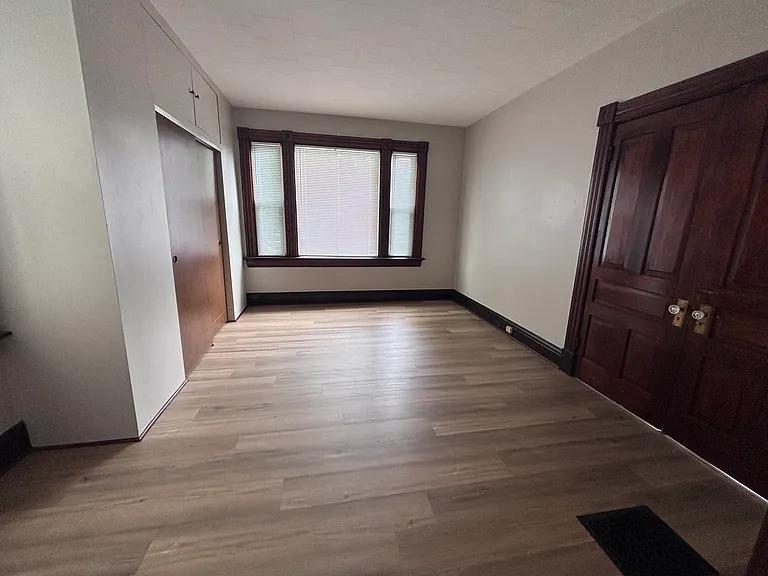 Large bedroom with oversized closet. Original pocket doors (not pictured) separate the bedroom from the living room/dining room space.