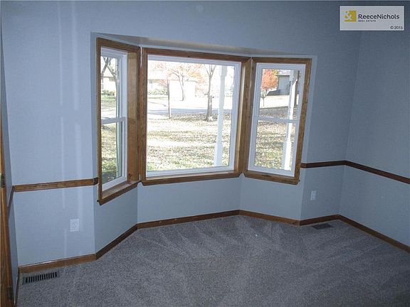 Spacious living room with lovely bay window and tray ceilings is a beautiful space to relax or entertain. Close the French doors for a cozy feel.