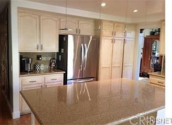 Large custom granite island with room for four barstools
