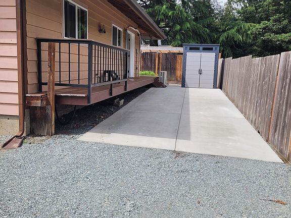 Private apartment entrance. Parking area and storage shed