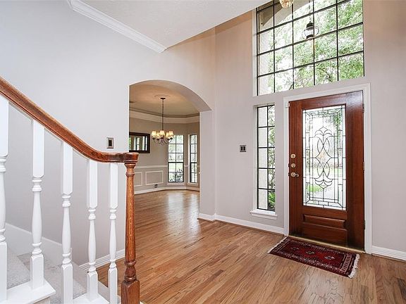 The elegant entry is nice and wide and features a leaded glass door and plenty of natural coming in through the 2-story windows.