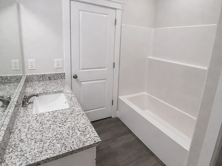 Convenient second full bath located near the guest bedroom.