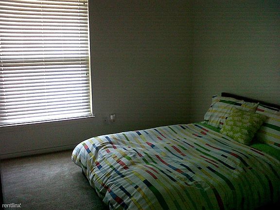 Spacious bedroom with large windows for natural light.