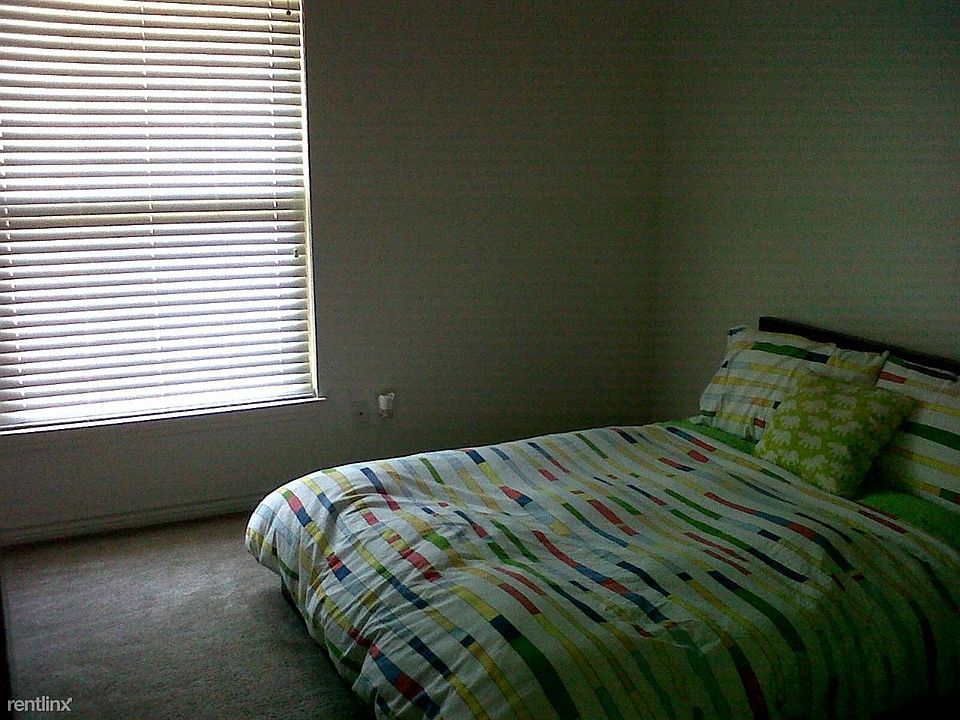 Spacious bedroom with large windows for natural light.
