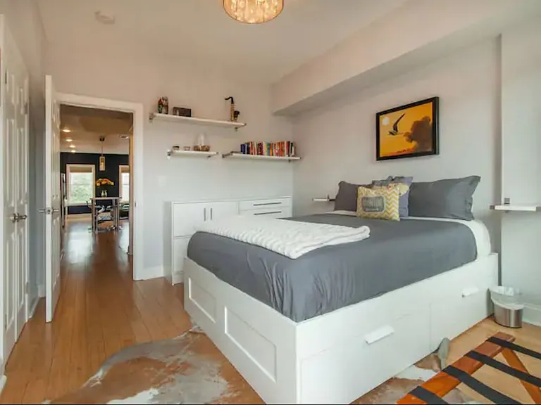 First bedroom with second bathroom just outside its door. This bedroom is on the same floor as the living room and kitchen, which is elevated up 1 floor from the street, offering enhanced privacy and security